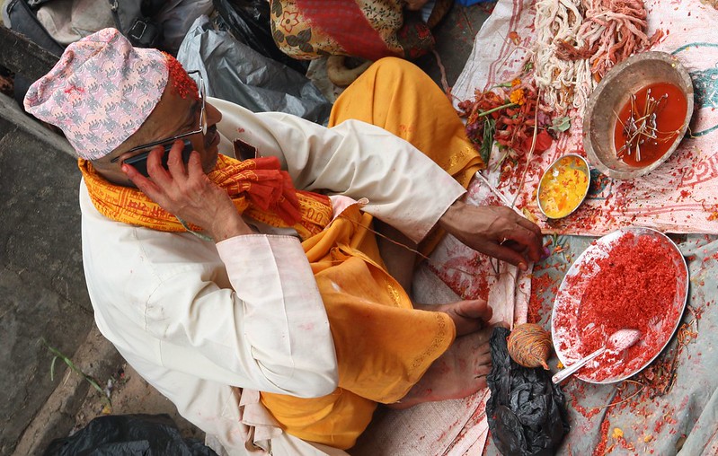 A Hindu preist on rakshya bandhan waiting for people to tie a thread